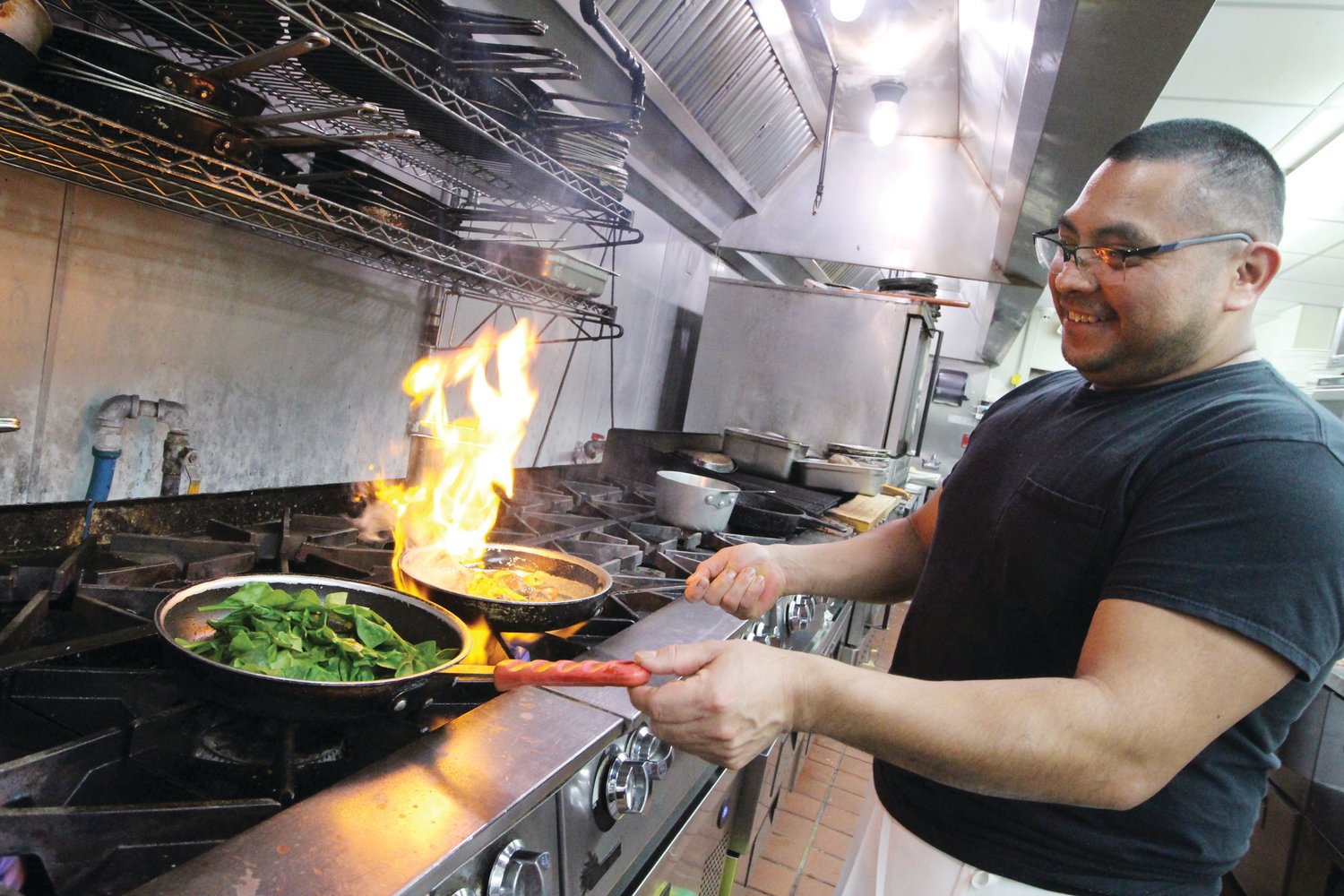 HE’S GOT GAS: Silvan Garcia, head chef at the Governor Francis Inn works his wonders with the help from an efficient crew at the multi-gas-burner stove.